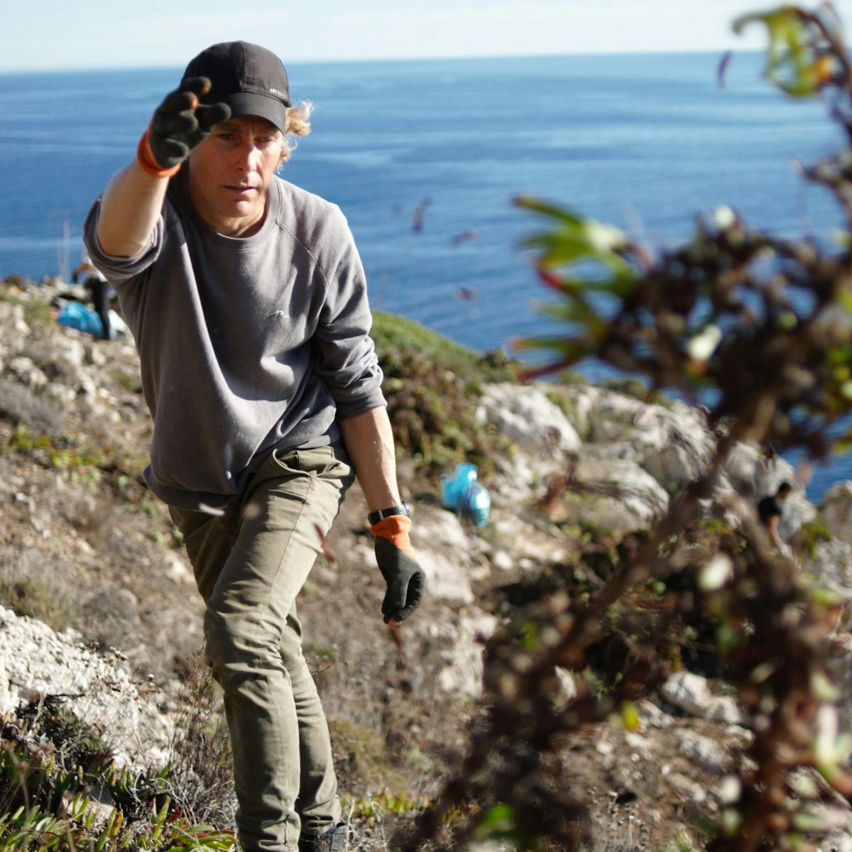 Matt, Mossy Earth co-founder, removing the invasive ice plant from the cliff area where we are striving to protect endangered plants. 