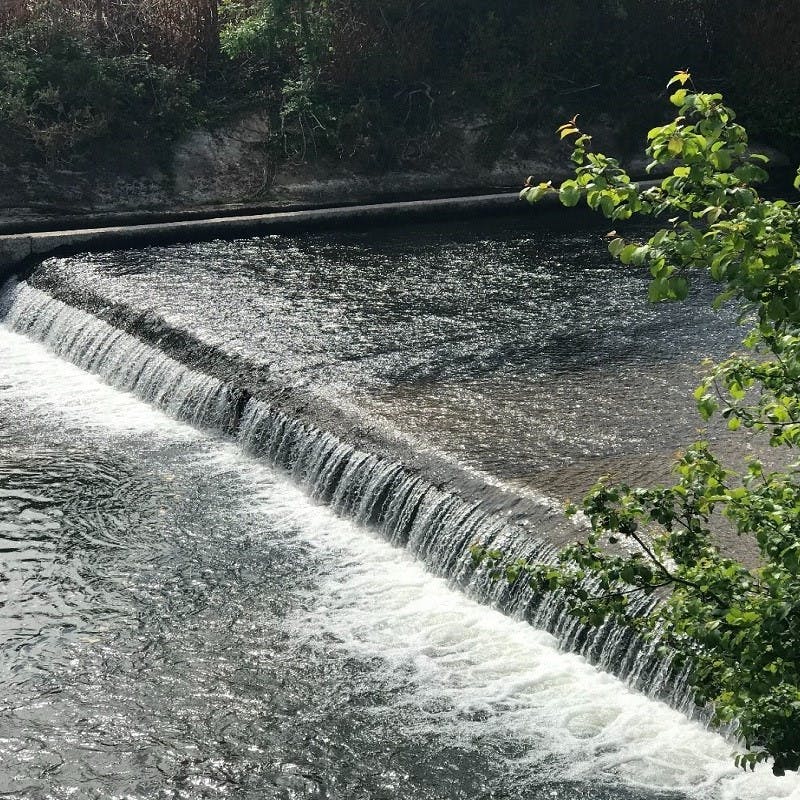 A weir or low dam regulating water flow. 