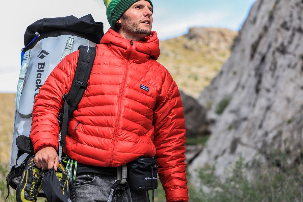 A climber at the crag with climbing gear wearing a sustainable fashion brand.