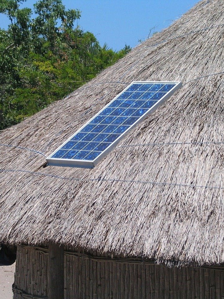 A solar panel on a thatched roof. A true eco home will harness the sun's energy for all your daily needs. 