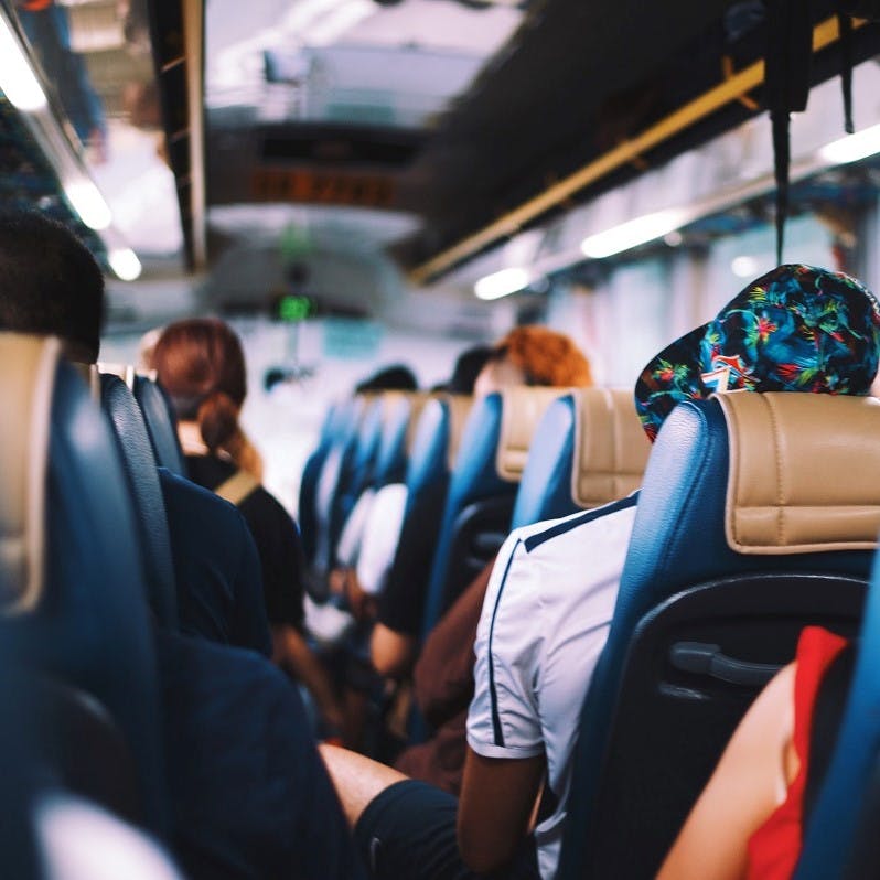 People on a long distance bus journey. Taking the bust is probably the most cost effective means to travel without flying.