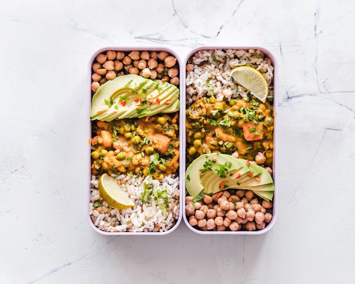 Being vegan is about being prepared. Here is vegan packed lunch box of curried chick peas, brown rice and avocado.