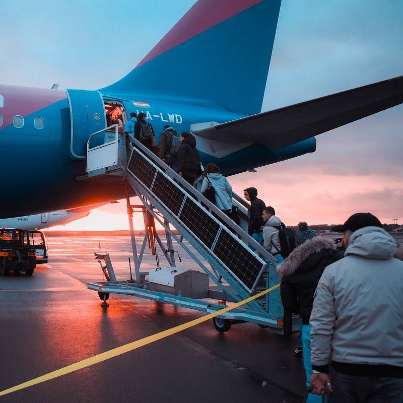 Passengers boarding at the rear of a budget airline aircraft. Flying economy class is a more sustainable way to fly. 