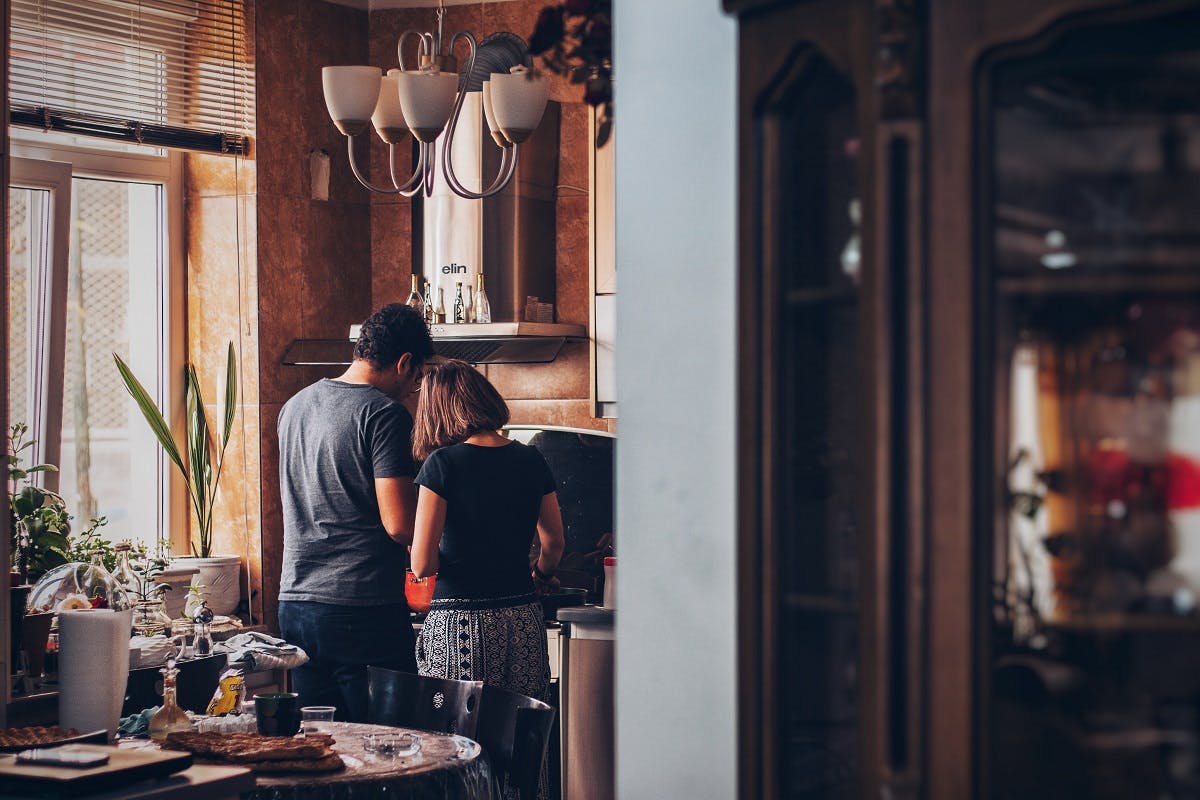 A couple making their dinner from scratch. Slow living is about enjoying the process as much as the result. 