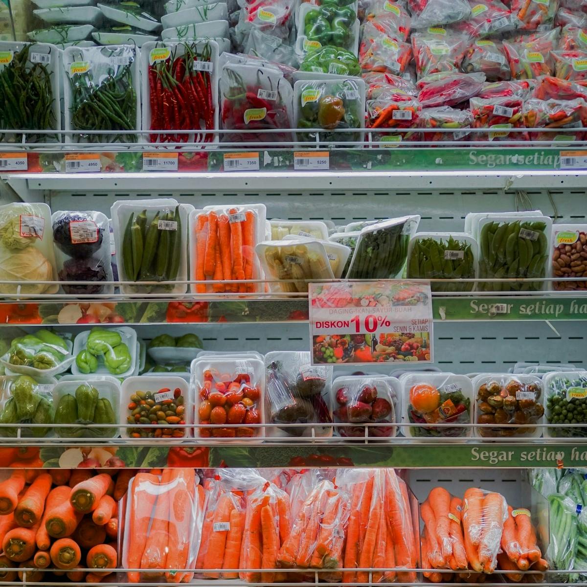 Various vegetables wrapped in plastic packaging in a supermarket. To refuse single use plastics such as needless packaging, is the first steps in living plastic free.