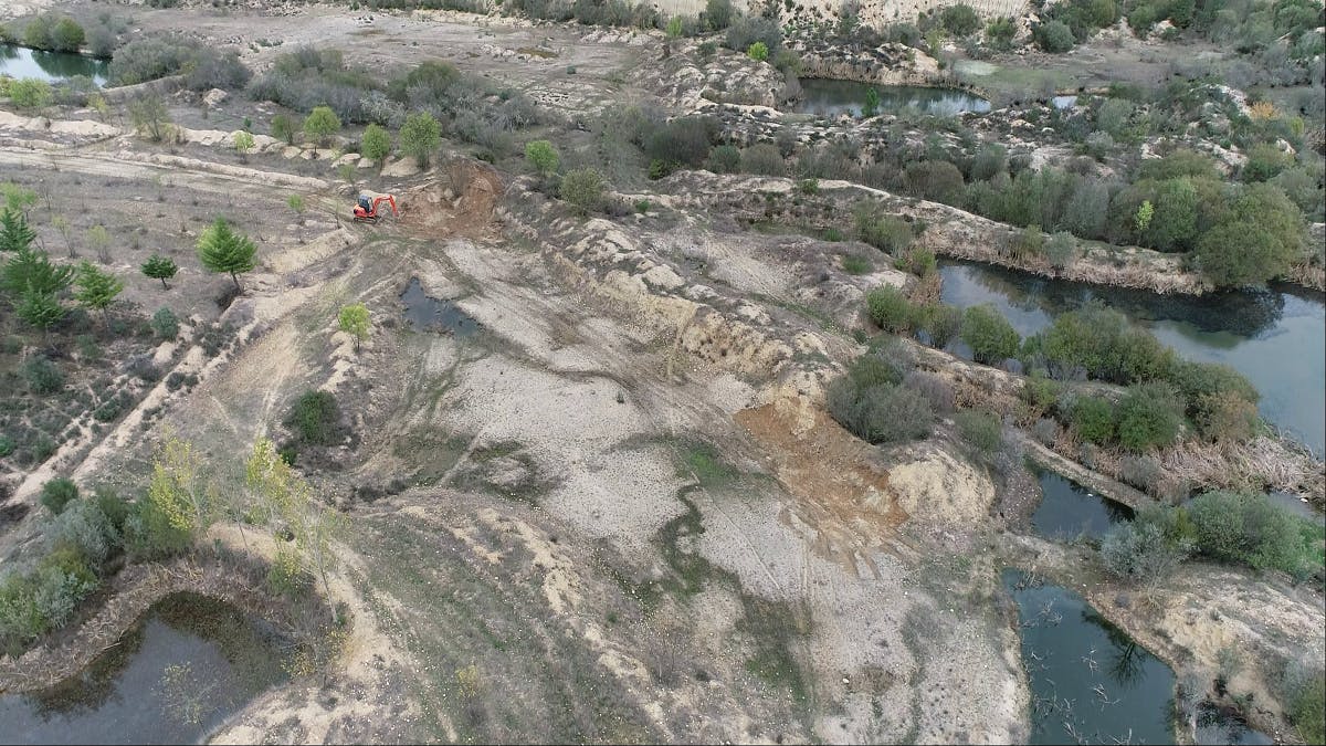 A digger doing earthworks at Paul de ToirÔes rewilding project in Portugal.