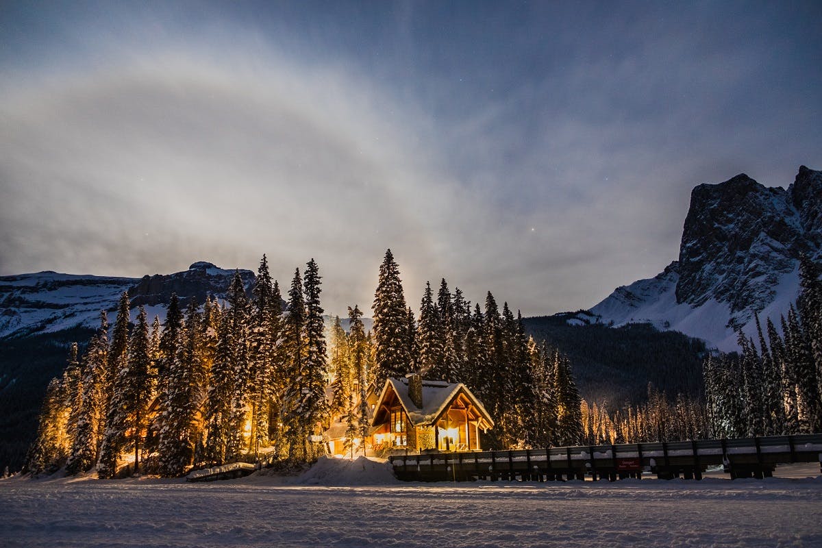 A well insulated home in the mountains surrounded by forest, snow and mountains