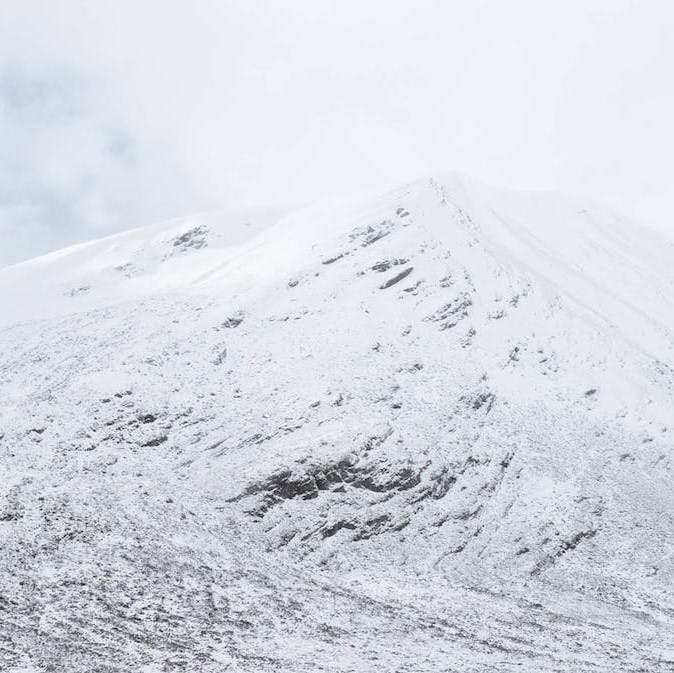 A lightly snow covered mountain. With warming temperatures and less snow cover, Scottish mountain hares are more vulnerable to predation in winter