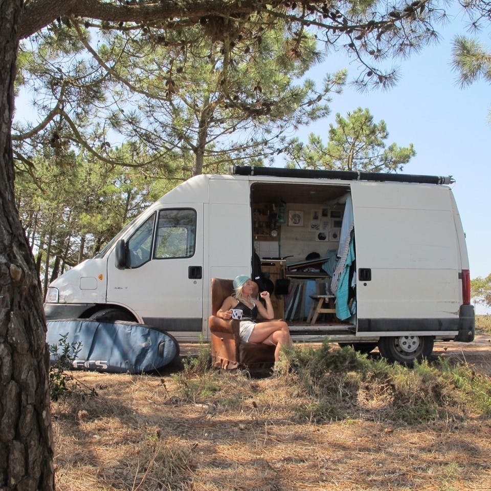 A surfer enjoying van life in the sun in Portugal