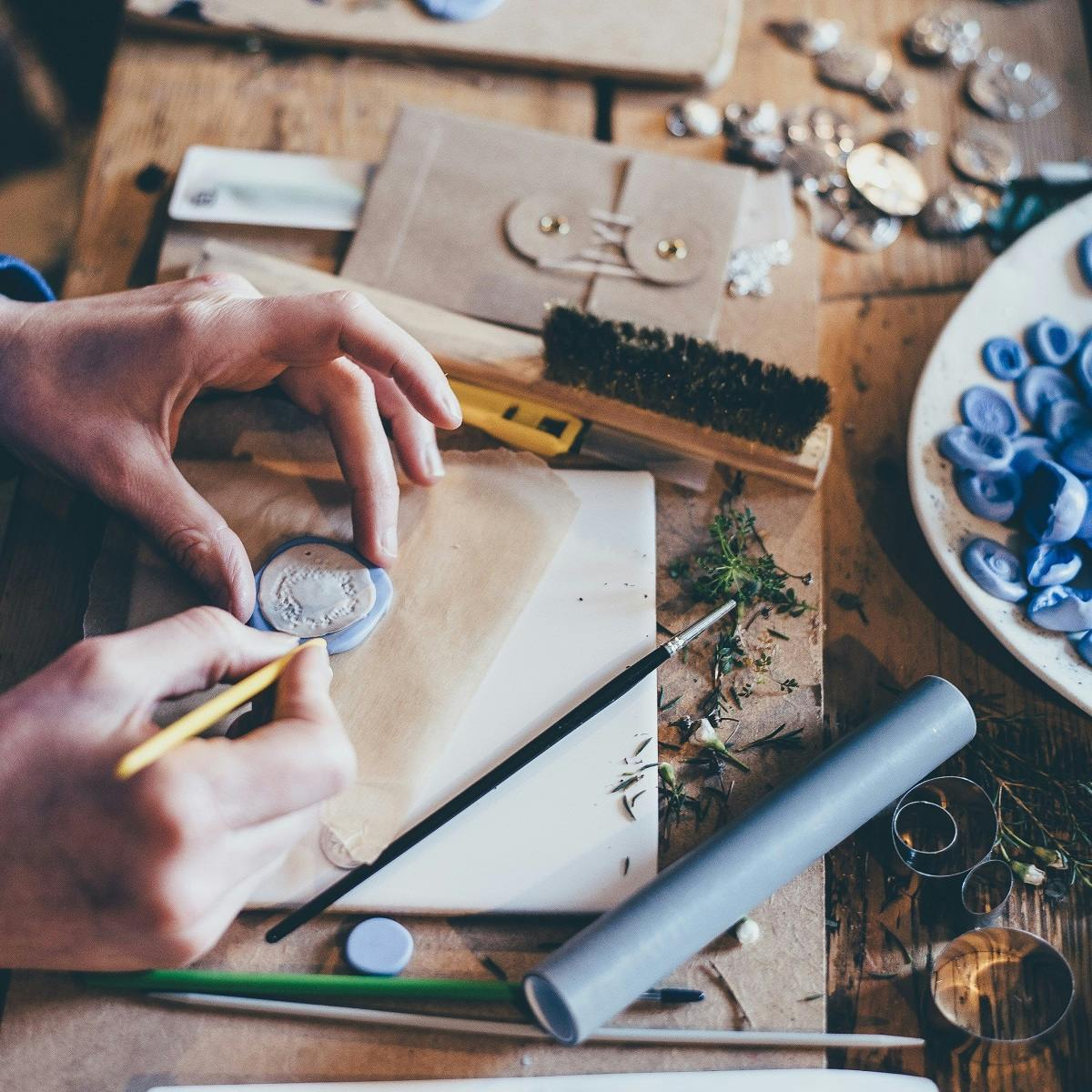 A person working on arts and crafts. Making your own Christmas decorations from recycled materials is an excellent way to make a sustainable Christmas.  