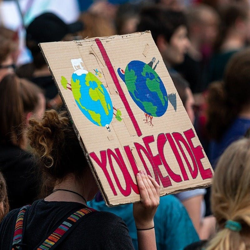 A protester holds up a placard on climate change as those demonstrated at previous COP conferences.