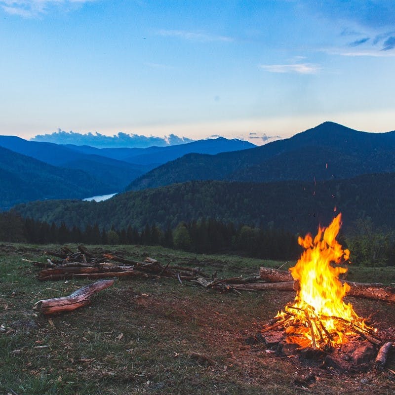 A camp fire with view of lake and mountains. Another great advantage of van life, the adventure!