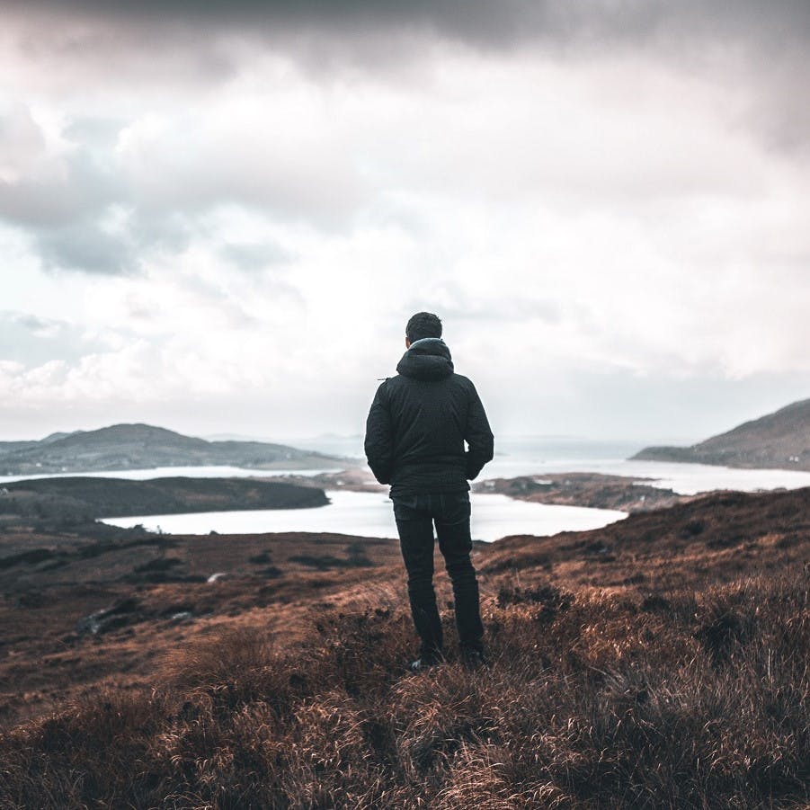 A man taking in a view in Scotland. Slow living is all about appreciating the little things in life