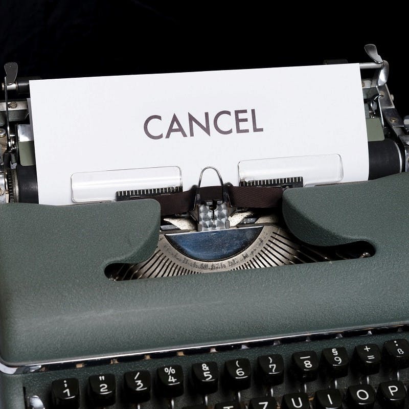 An old typewriter with a paper titled cancel. Cancelling your flight ticket if you can't go, is key to sustainable flying as it means the same seat can be re-sold and not fly empty. 