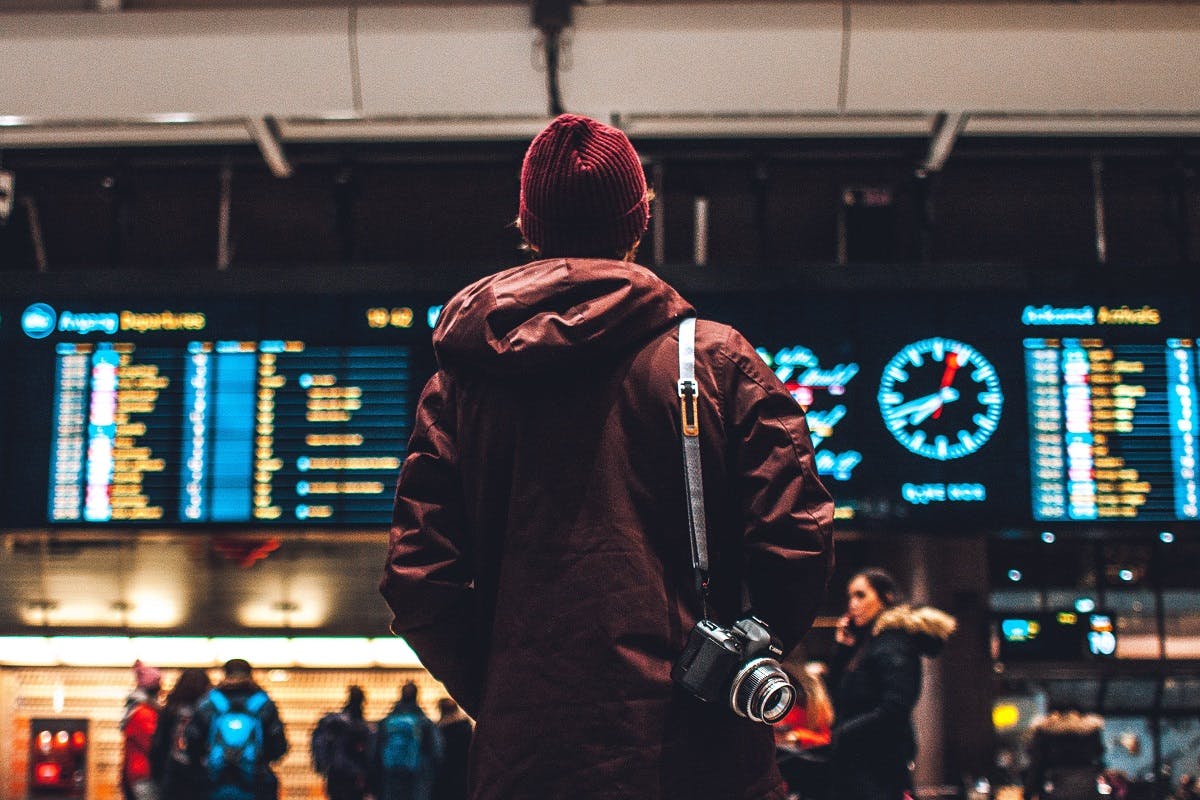 A guy checking the departure boards at the airport