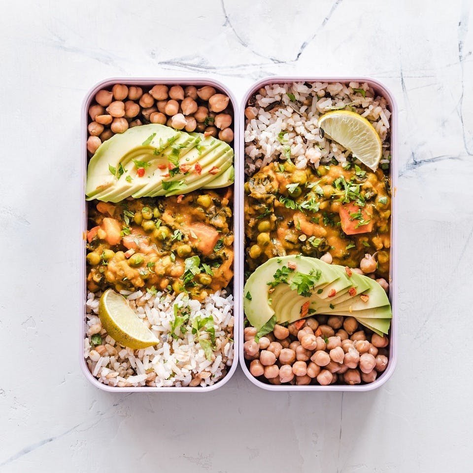 Being vegan is about being prepared. Here is vegan packed lunch box of curried chick peas, brown rice and avocado. 