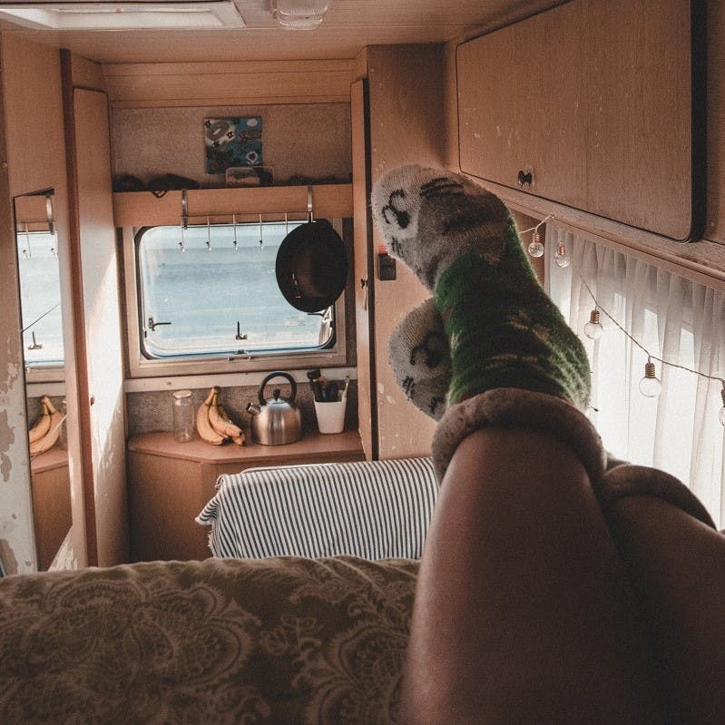 A lady relaxing inside her camper van. #vanlife