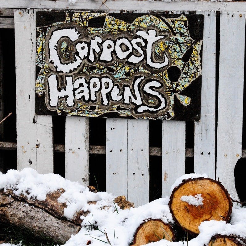 A garden composter and logs covered in snow. Home composting is easy and free. What are you waiting for?