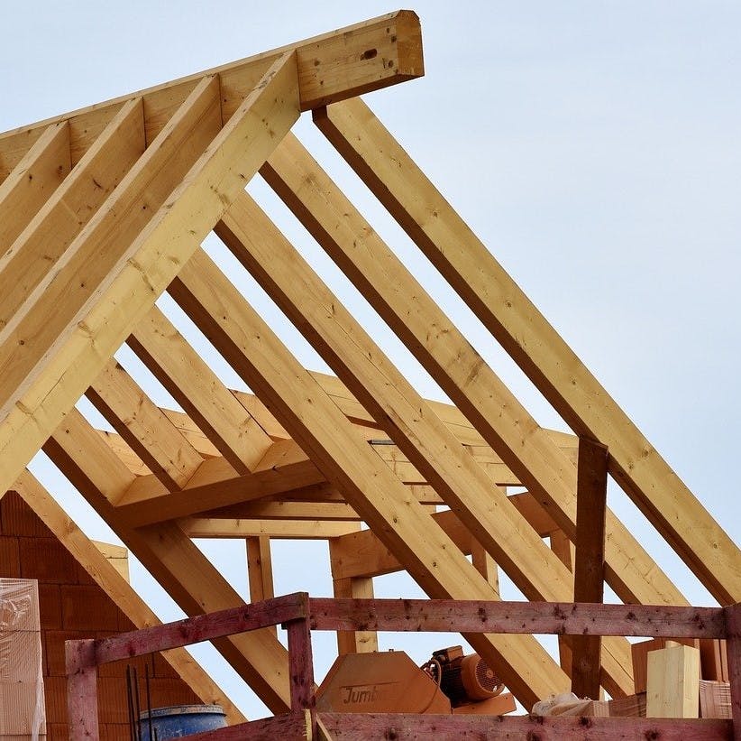 The frame of a timber roof. Hempcrete, a sustainable substitute for concrete, combines well with timber to create a strong eco house.