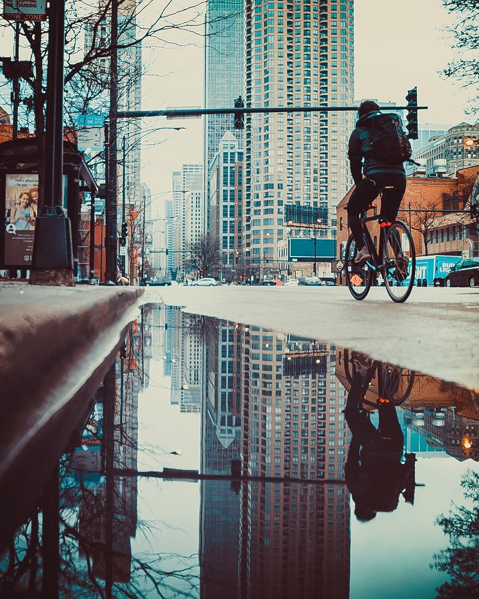 A man riding to work in a city. 