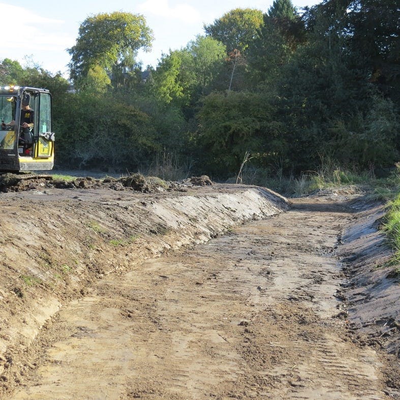A digger excavating a pond at the Mossy Earth Pond Restoration project in Shropshire.
