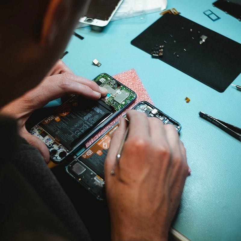 A mobile phone being repaired. Repairing used items comes under tier five (Materials Recover) of the Zero waste hierarchy.