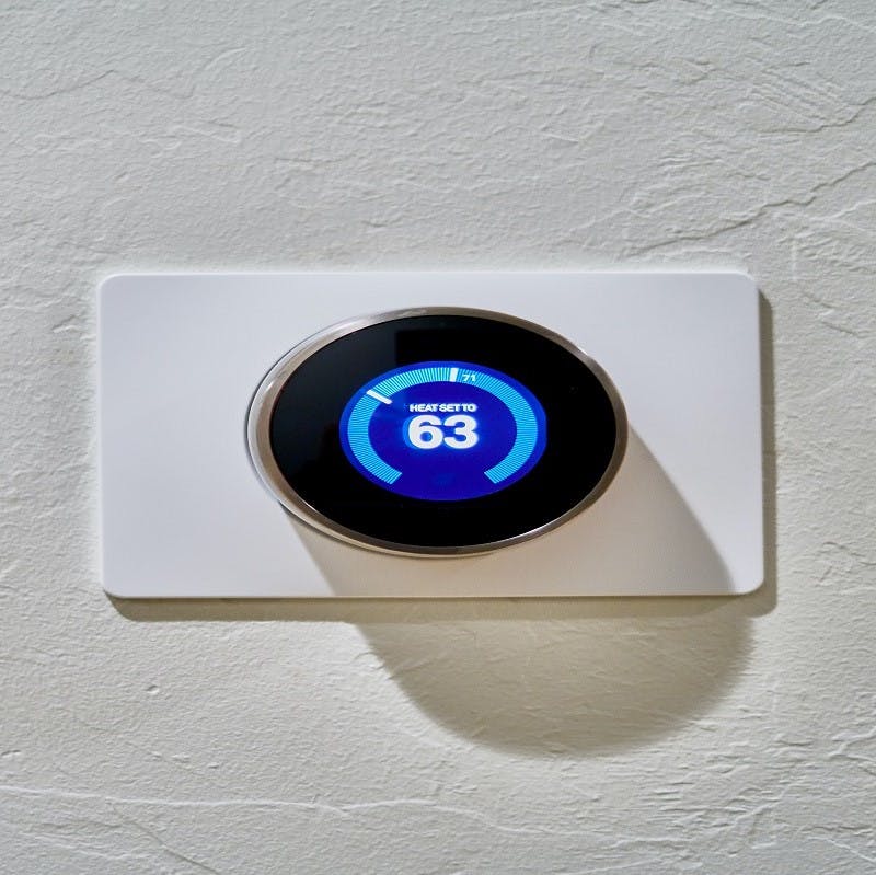 A programmable thermostat set to 63 degrees Fahrenheit.  Programmable thermostats, an essential for every eco house, help prevent energy loss by managing your usage to suit your needs.