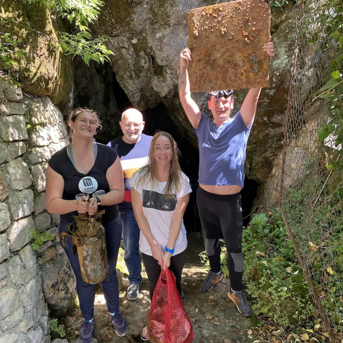 the team of divers outside the Predolac cave after the waste removal event.