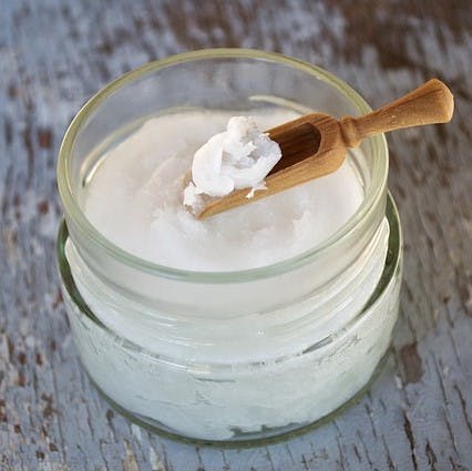 A jar of Coconut oil used for zero waste lotion.
