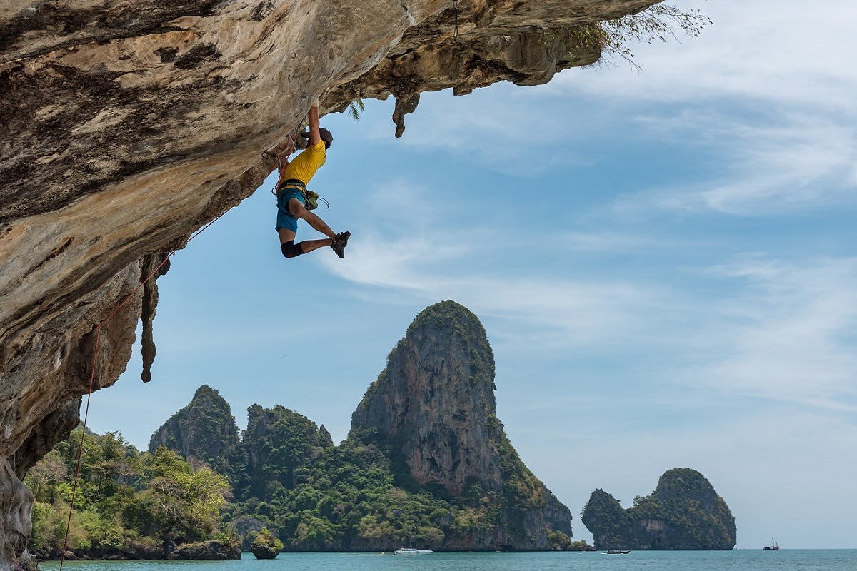 A rock climber hangs from a clifff.