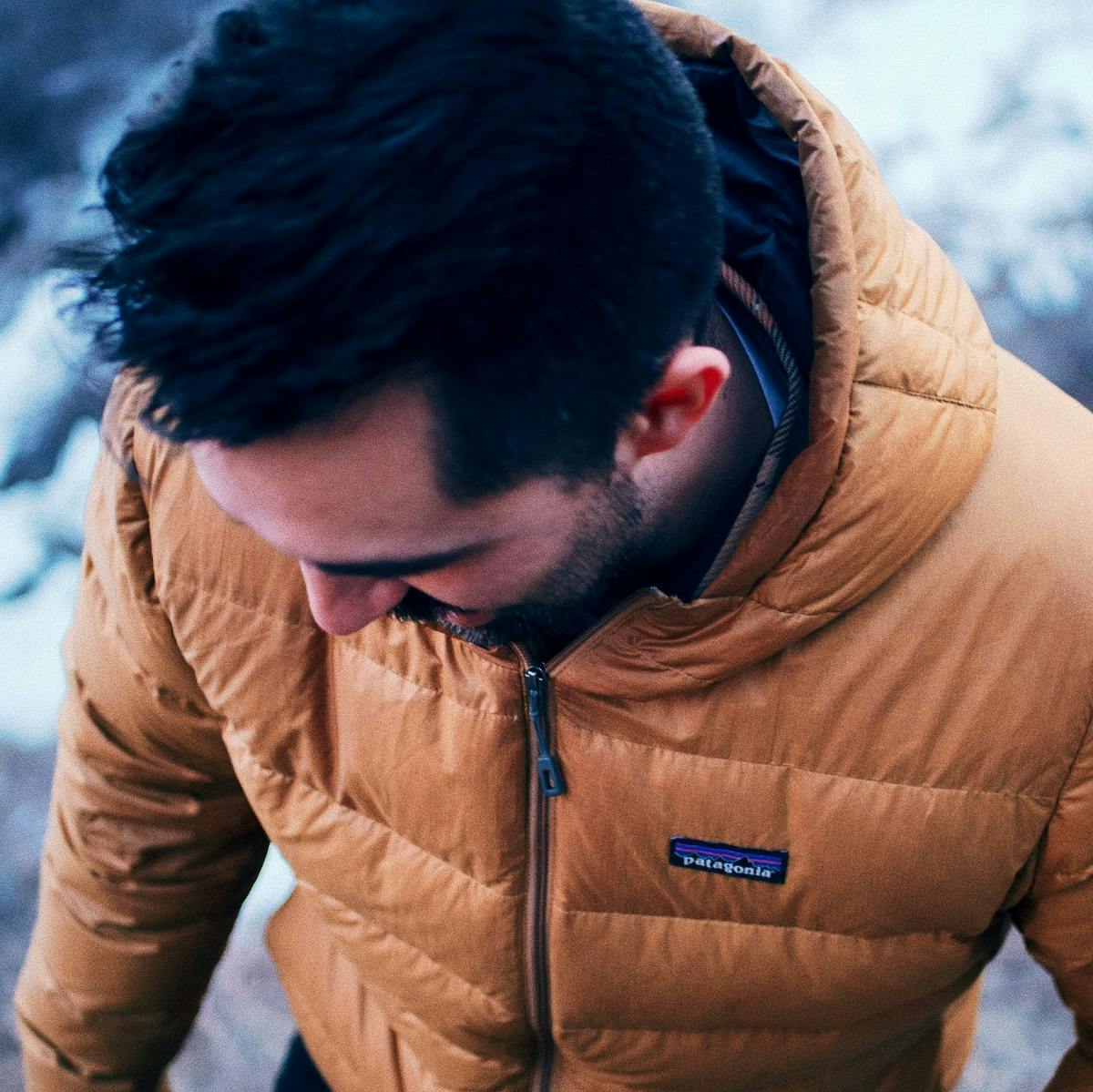 A man wearing a Patagonia jacket. Patagonia are advocates of a circular economy 