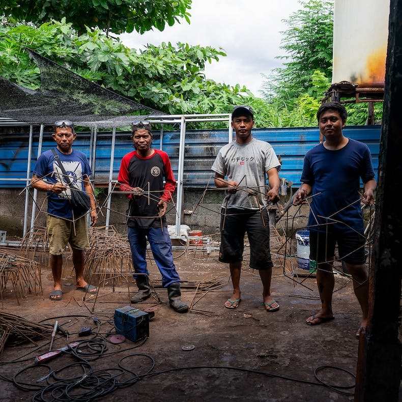 Indonesia workers constructing reef restoration structures.