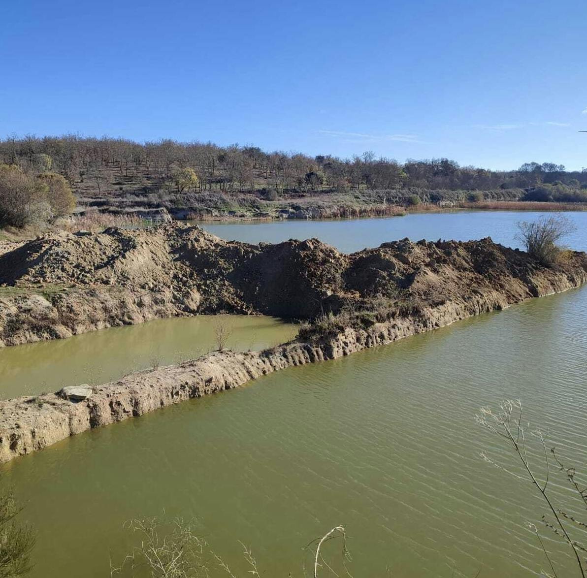 blue lake at mossy earth and rewilding portugal rewilding a quarry project