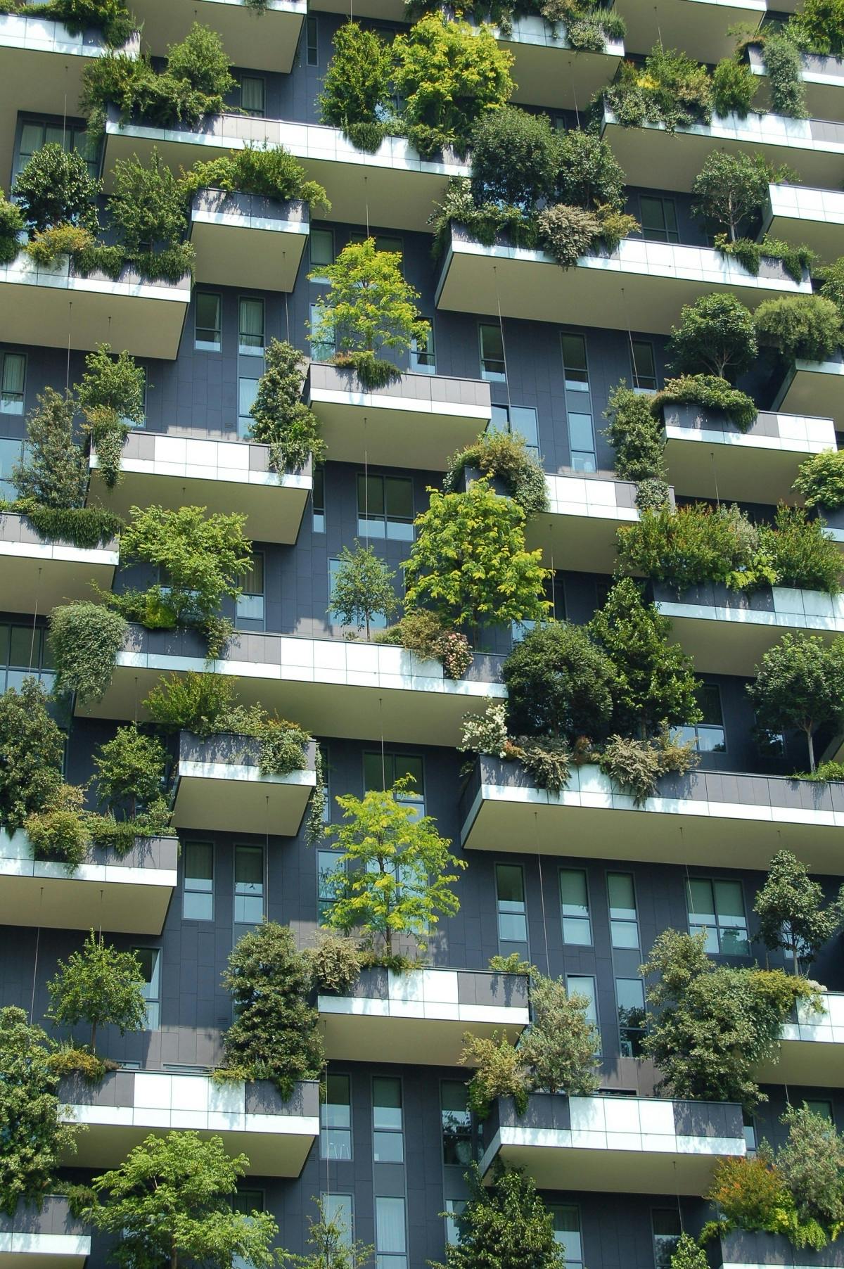 An apartment block with trees on every balcony