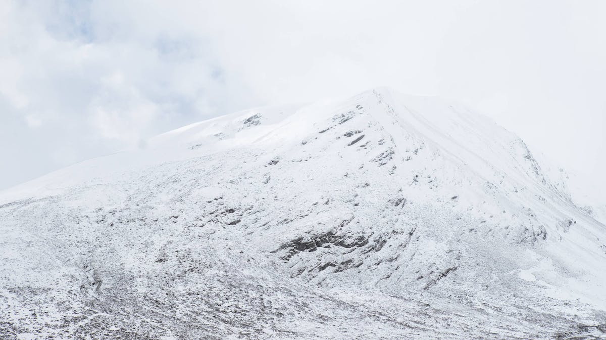 A lightly snow covered mountain. With warming temperatures and less snow cover, Scottish mountain hares are more vulnerable to predation in winter