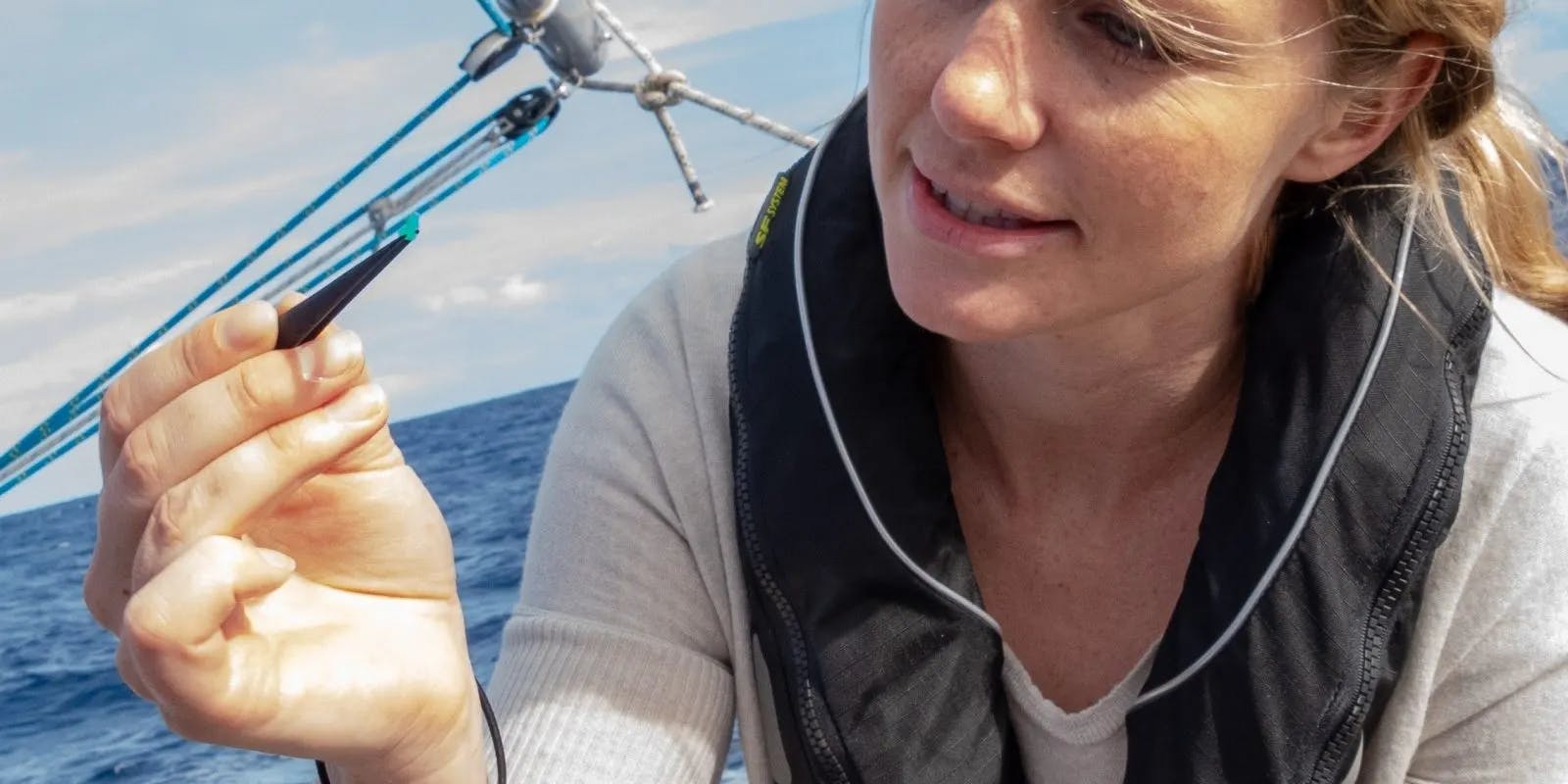 A lady investigating ocean plastics and microfibres on board a research yacht