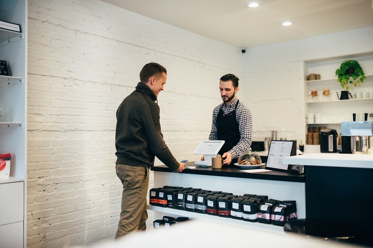 A man exchanging tidal revival app points for a coffee