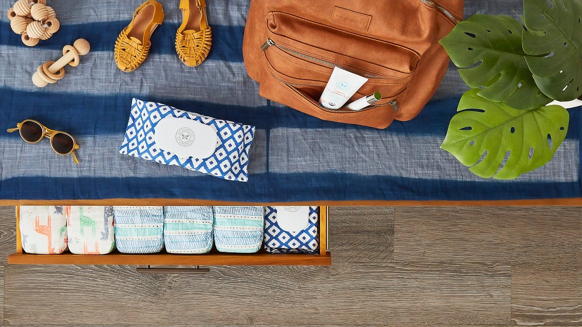 A baby changing table with a drawer full of reusable nappies.