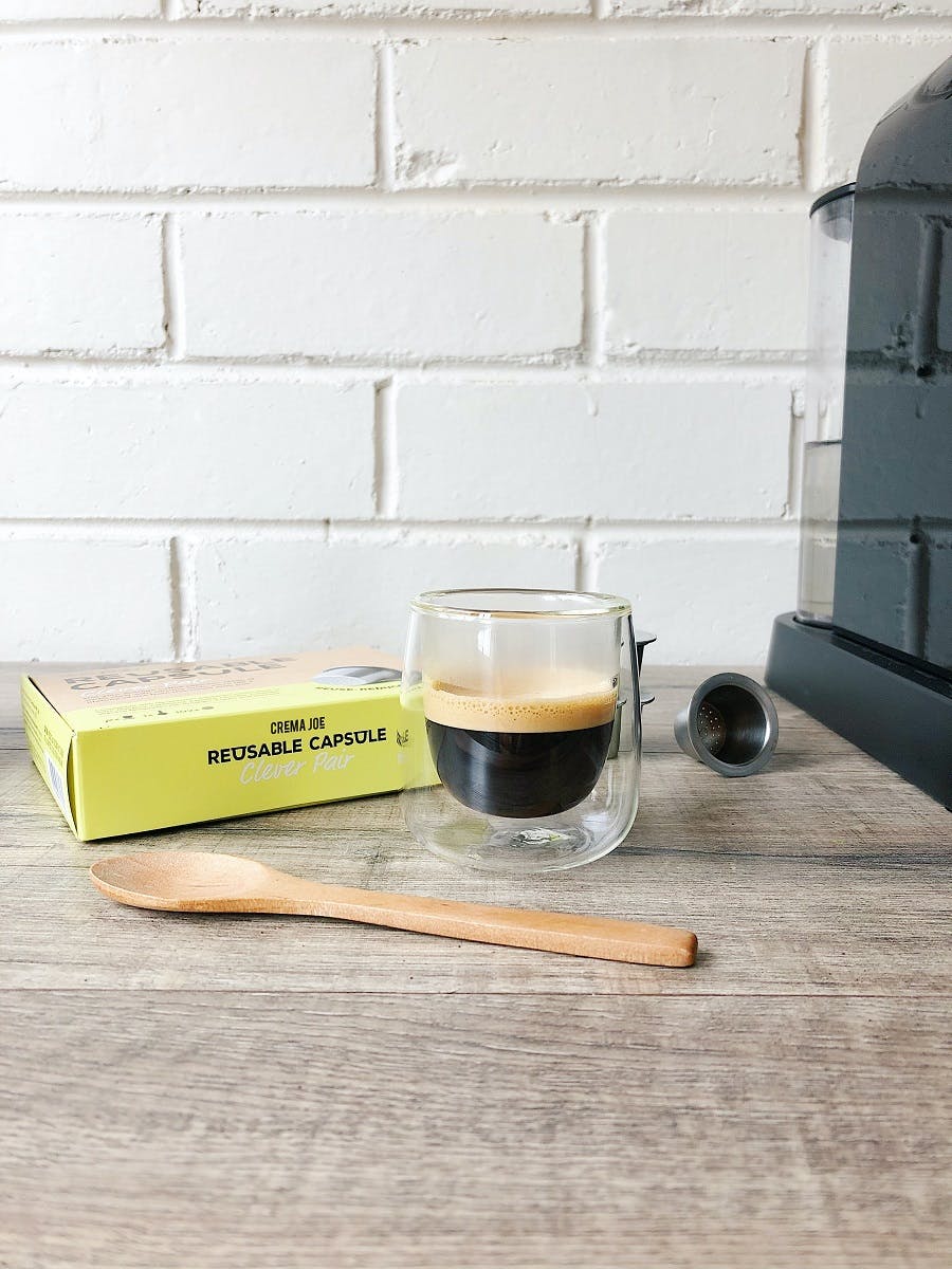 A glass of coffee from a reusable coffee capsule in an office.