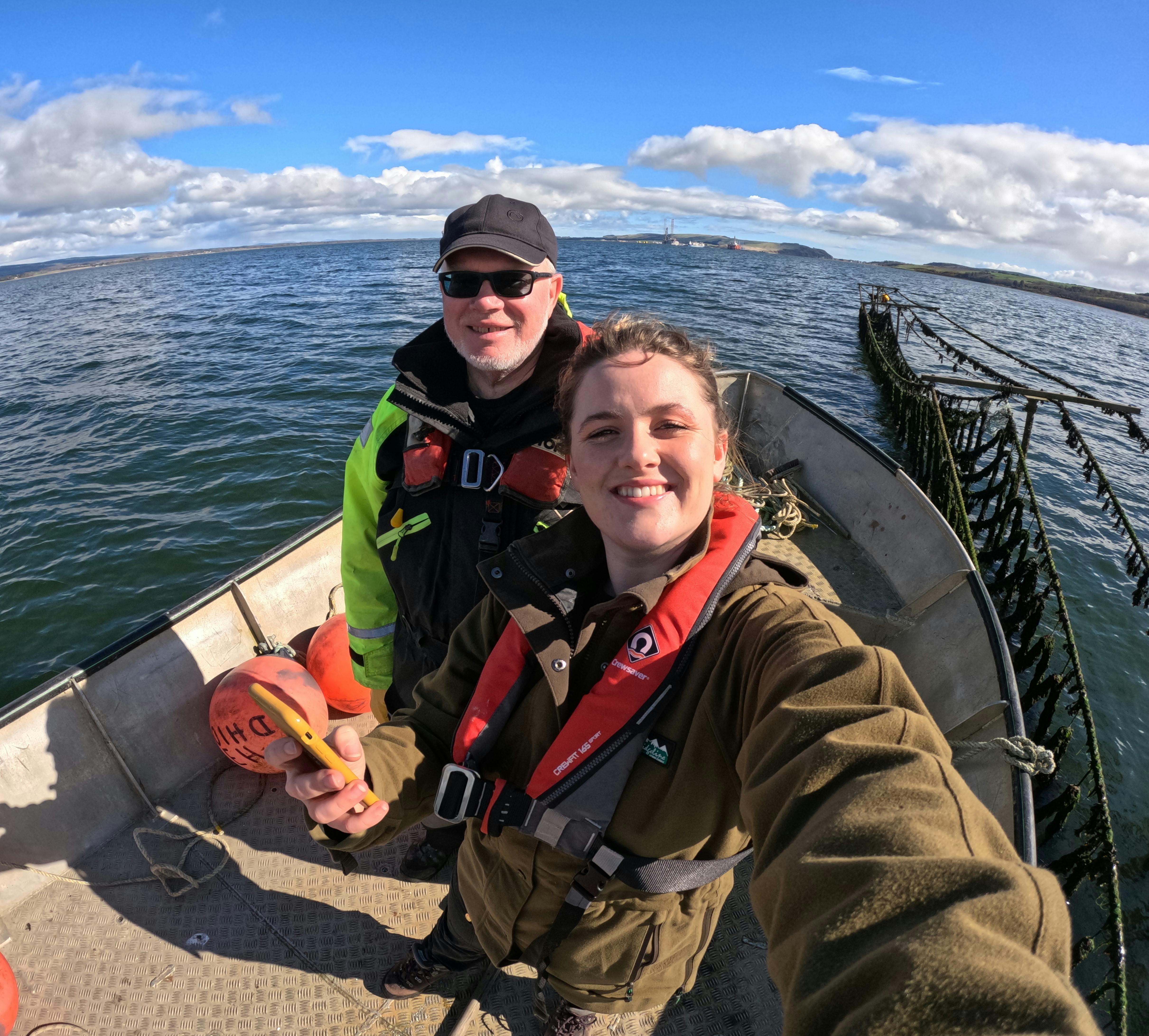 Andrew from Moray Ocean Community and Isla from Mossy Earth on a boat
