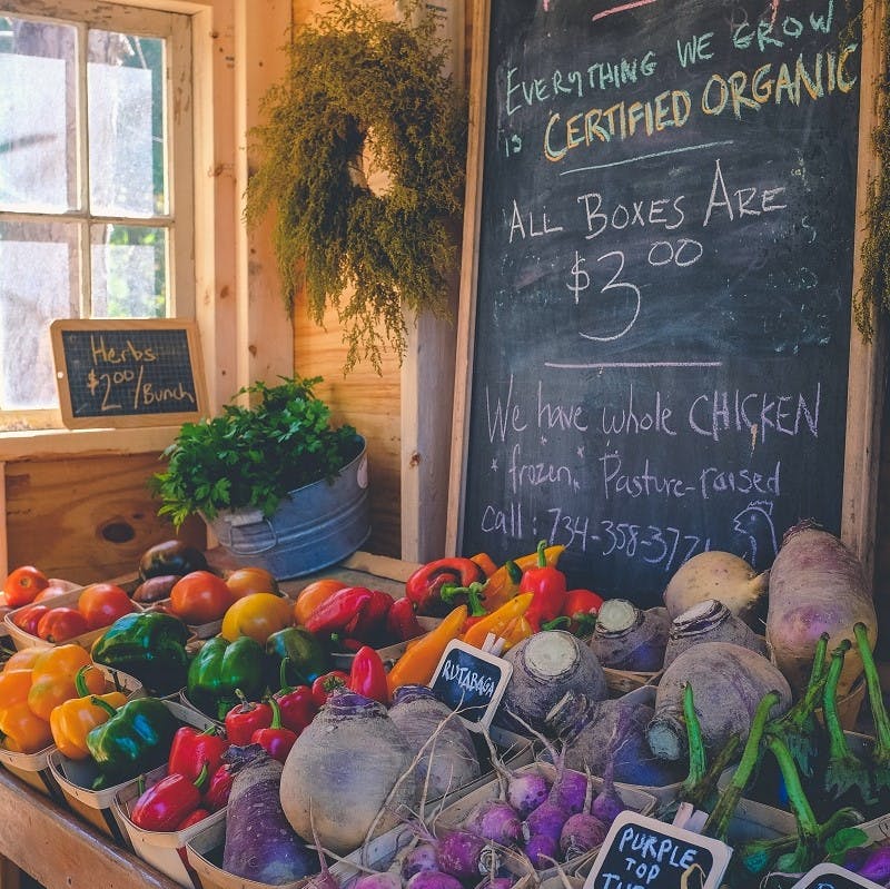 An organic food store advertising seasonal boxes of local vegetables. Eating the seasons means fresher produce, consumed closer to harvesting and with higher in nutritional value