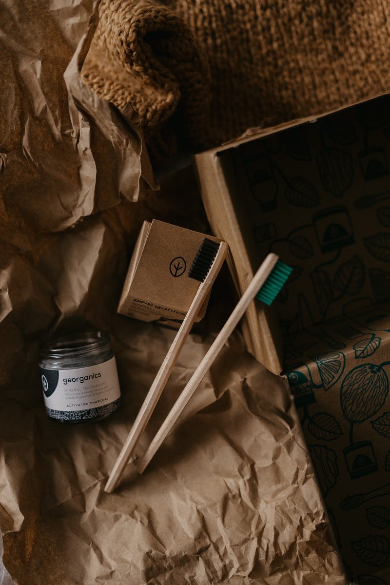 Two bamboo toothbrushes and a plastic free packaged toothpaste. An essential accessory for living plastic free.