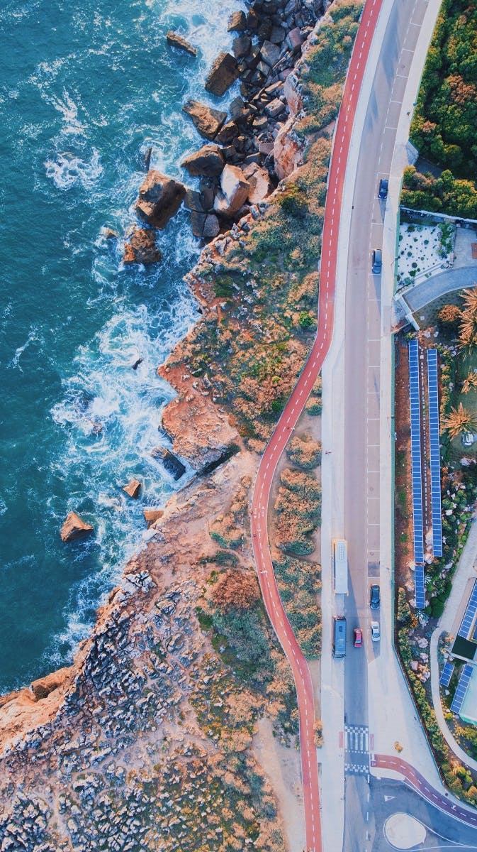 An aerial view of a cycle lane by the coast in Cascais. Many people use this lane to green commute to and from Cascais, Portugal.