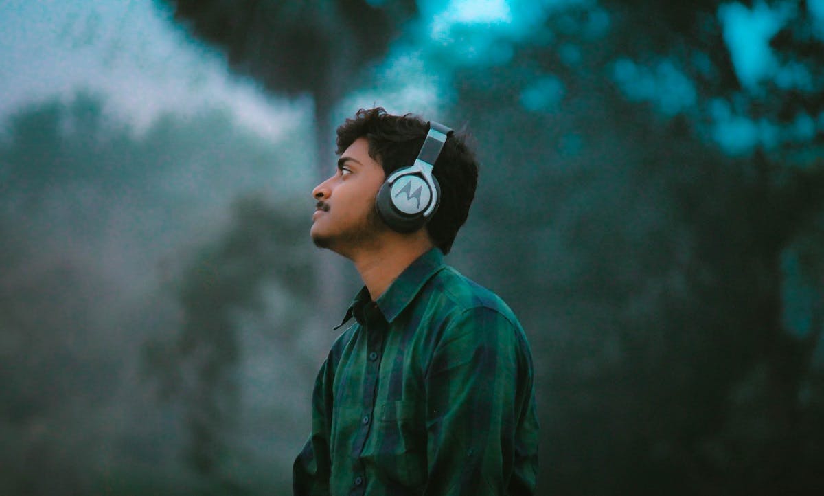 A man listening to a podcast in nature