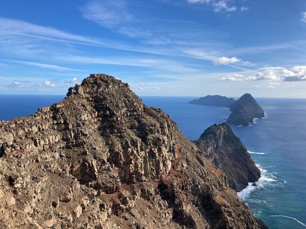Rocky cliff faces of Desertas Grande island, the location of Mossy Earth's rewilding project to rescue endangered snail species.