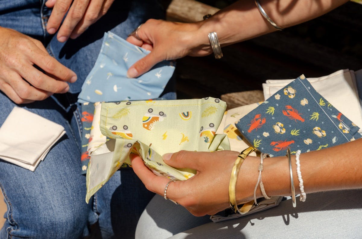 People with reusable fabric bags. Investing in a selection of different sized fabric bags will be very handy on your journey to a zero waste lifestyle.