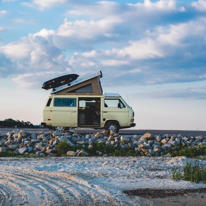 An old VW transporter parked at the beach