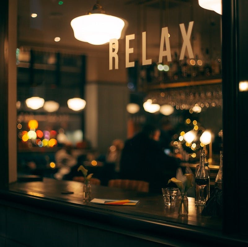 Looking in through a restaurant window at night. Being vegan means you don't have to miss out on eating out. Fortunately, vegan restaurants and cafes are popping up all over. 