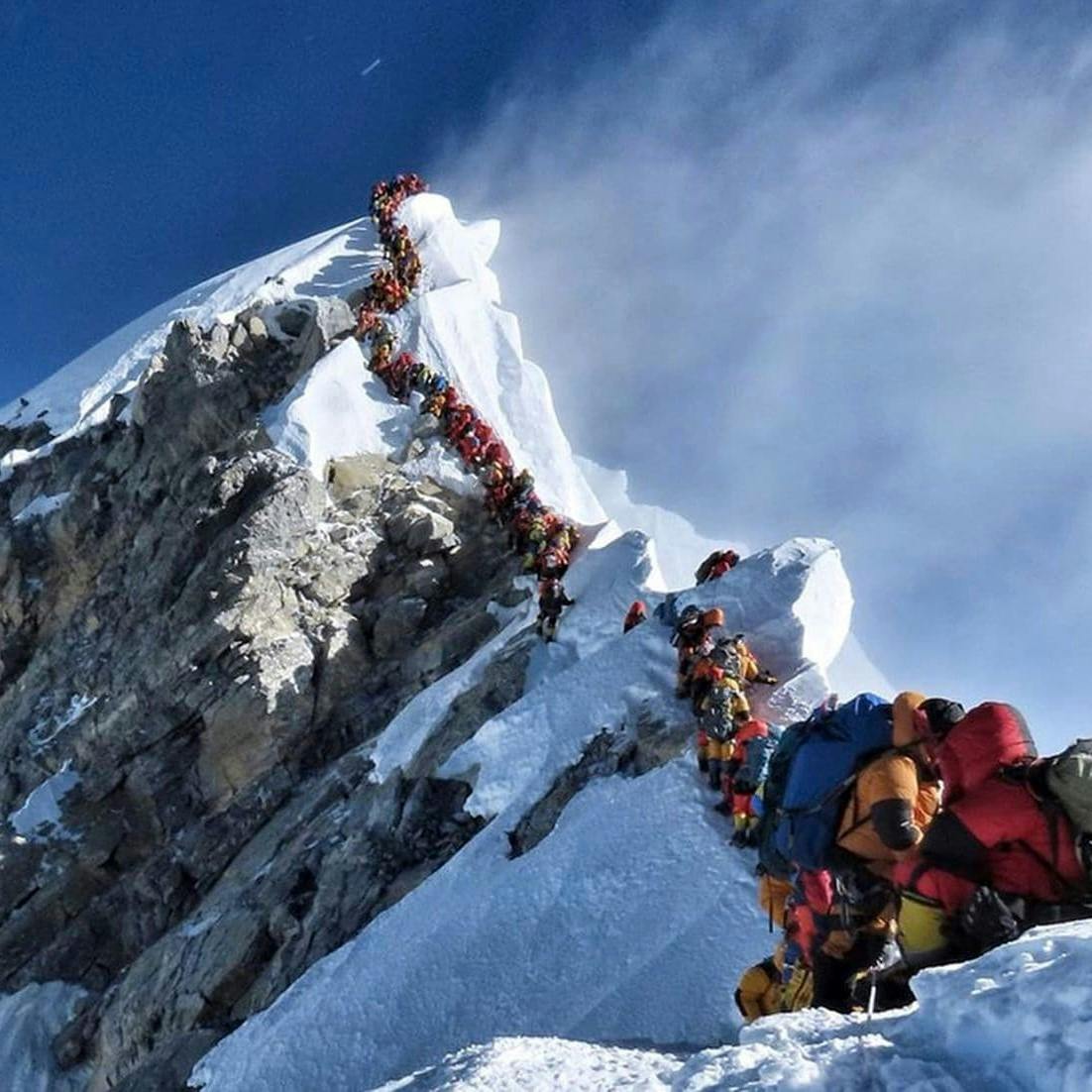 A dangerously long queue of climbers at the summit of Mount Everest. This is definitely not responsible travel!