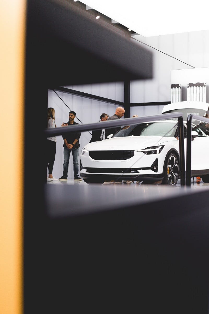 People viewing a hybrid concept car at a car show